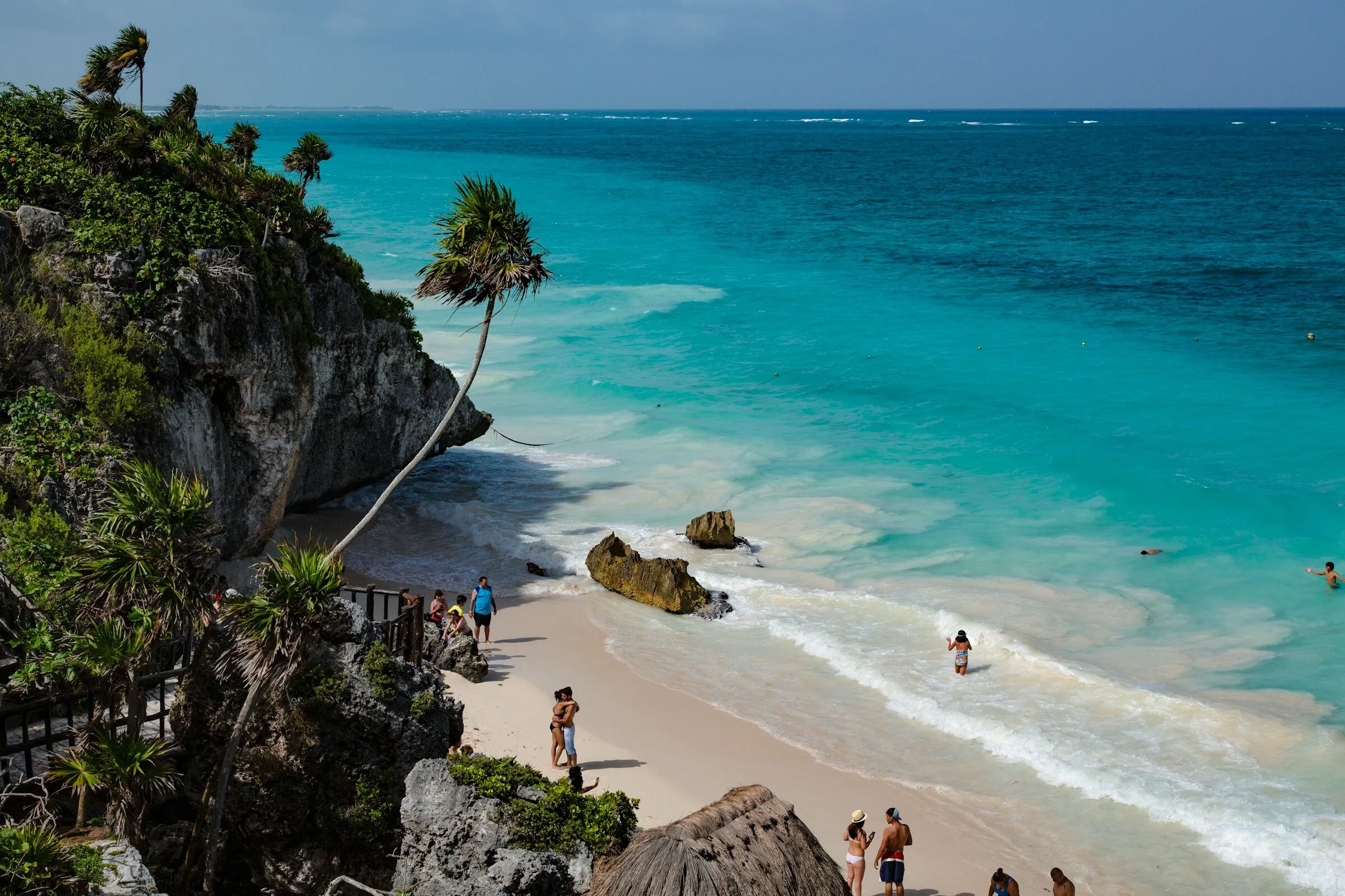 Turquoise Caribbean water meeting the rocky coast at Tulum in the Riviera Maya